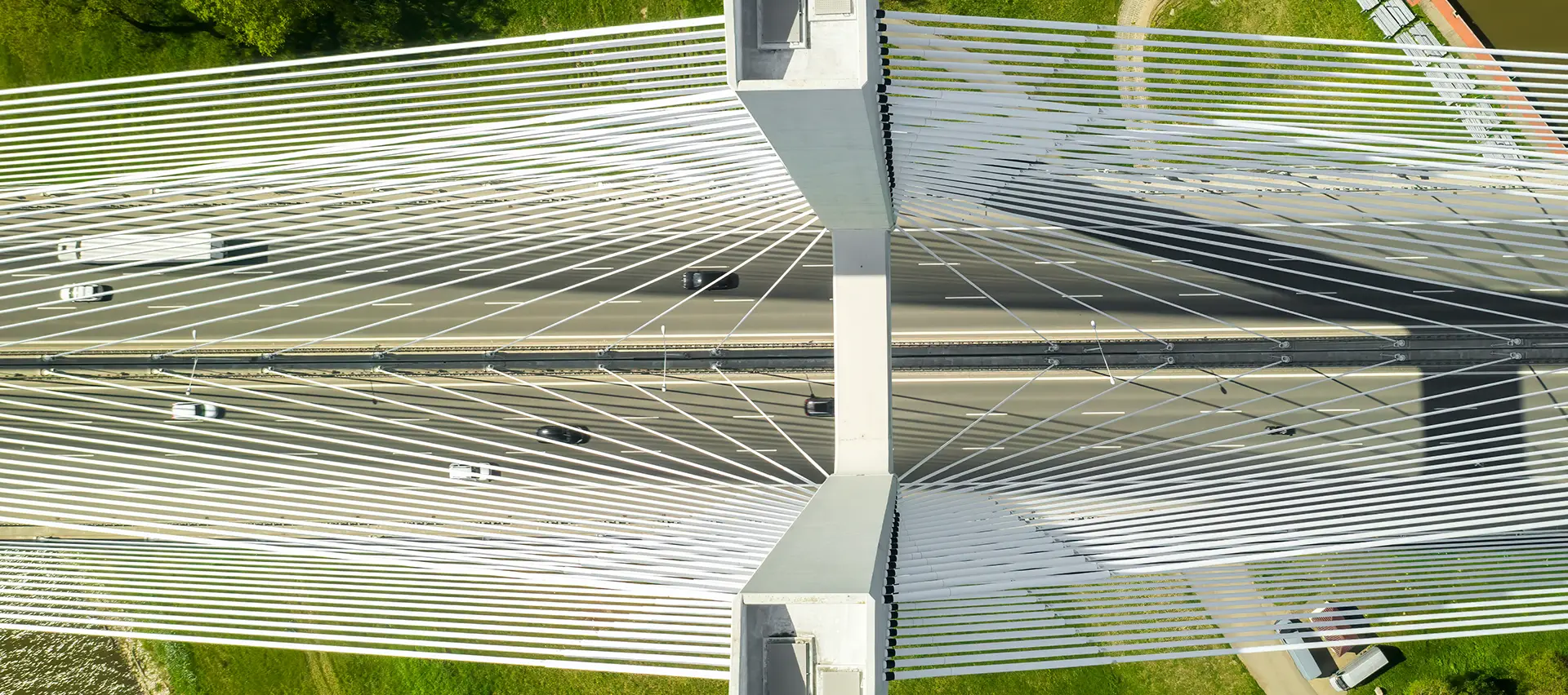 A birds-eye view of a bridge with several cars crossing, showing the complexity of structural engineering and the importance of reliable connections.